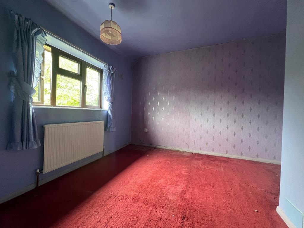 Lot: 13 - TWO-BEDROOM SEMI-DETACHED HOUSE - Bedroom two with radiator and widow to the rear